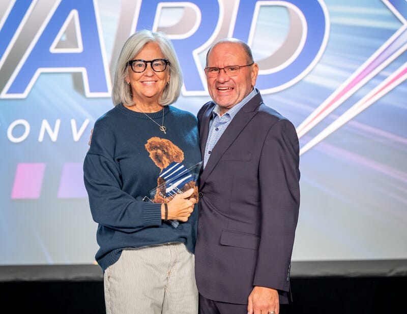 An image of the owners holding the award.